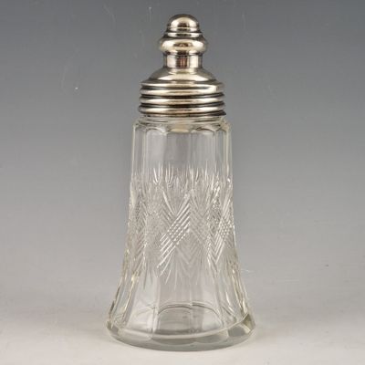 an antique cut glass salt shaker with a silver lid