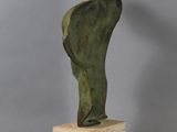 bronze sculpture of a man standing on a marble block