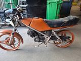 a motorcycle that is parked in a garage next to other motorcycles