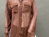 an image of a mannequin wearing a brown shirt and black leggings
