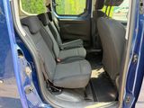 a blue van with two seats in the back of it