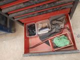 a red tool box filled with assorted items