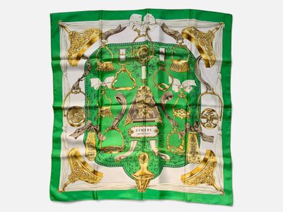 a green and white square scarf with a picture of a horse and other animals
