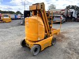 a small yellow machine that is parked in the dirt