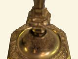 a gold candle holder on a white background