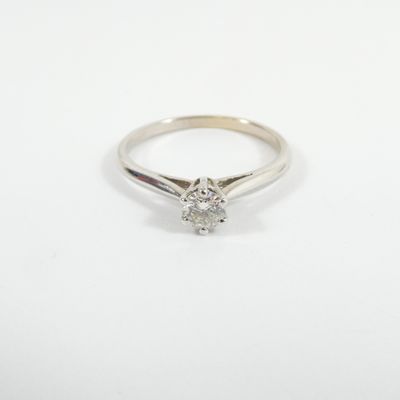 a white gold engagement ring with a single diamond