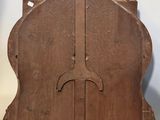a wooden clock hanging on the wall in the room