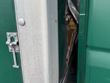 a close up of a door handle on a green truck