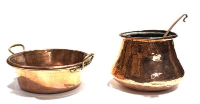 two pots and a spoon sitting next to each other