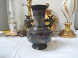 a vase that is sitting on a table next to a lamp