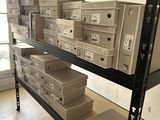 boxes are stacked on a shelf in a room with a large window