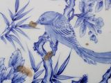 a blue and white plate with a bird on it