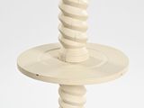 a white candle holder with a spiral design on top of it