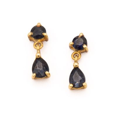 a pair of sapphire earrings on a white background