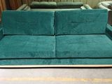 a green couch and a blue chair in a room