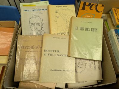 many books in a box on a table