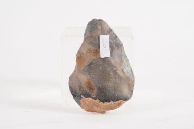 a rock with a tag on it sitting in the snow