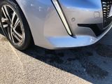 a close up of the front bumper of a silver car
