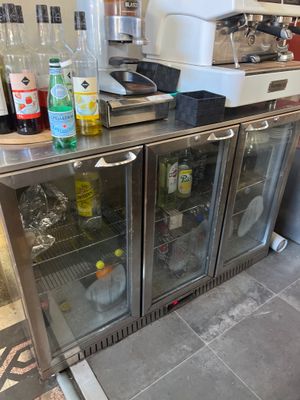 many bottles of alcohol on the counter in the kitchen