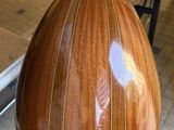 a person holding a large wooden object in their hand