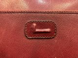 a close up of a red purse with a metal clasp
