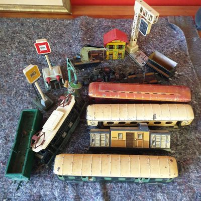 a lot of toy trains on the floor next to each other