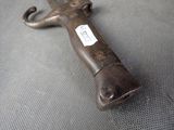 a metal object with a tag on it sitting on a table