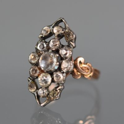 a close up of a diamond ring on a reflective surface