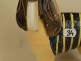a dog figurine that is wearing a sweater
