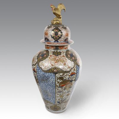 an image of a vase with a bird on top of it