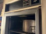 an open oven with pots and pans inside of it