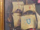 a painting of a ship on display in a gold frame