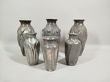 four vases that are sitting on a white surface