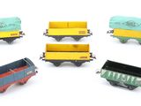 several toy trains are arranged in a circle on a white surface