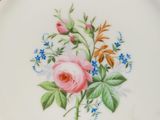 a plate with a floral design on it sitting on a table
