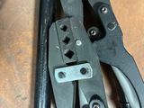 a pair of pliers and a pair of scissors on a table