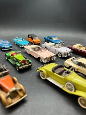 a lot of toy cars that are sitting on a table