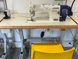 a yellow chair sitting in front of a sewing machine