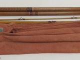 two wooden sticks and a cloth bag on a table