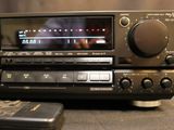 a radio that is sitting on a table next to a remote