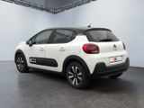 the rear of a white citrole car parked in a garage