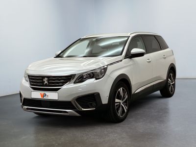 a white suv is parked in a room with a black floor