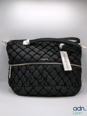 black quilted shoulder bag with silver zippers and a tag on it