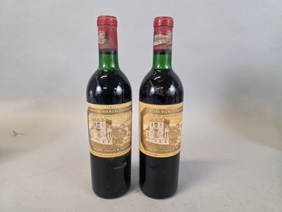 two bottles of wine sitting on top of a table next to each other