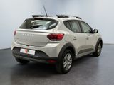 the rear end of a white car parked in a room
