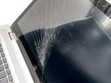 a broken screen on a laptop that is sitting on a table