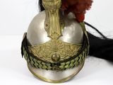 a red bird sitting on top of a silver helmet