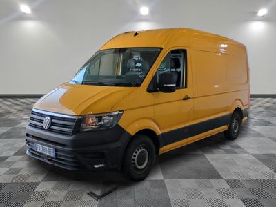 the yellow van is parked on a checkered floor in the garage