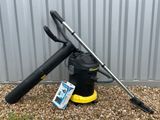 a black vacuum cleaner sitting on top of a gravel covered ground