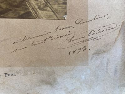an old photo of a man riding a horse on a track